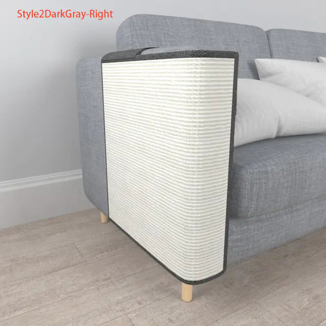 Cat scratcher against a gray sofa with white cushions on a wooden floor.