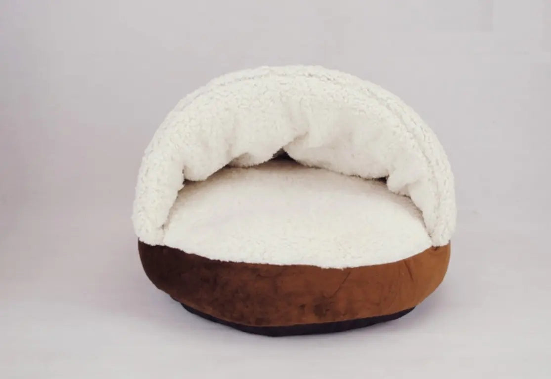 Pet bed with white fleece top and brown base on a light gray background