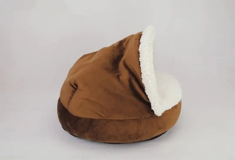 Brown pet bed with white interior on a light gray background