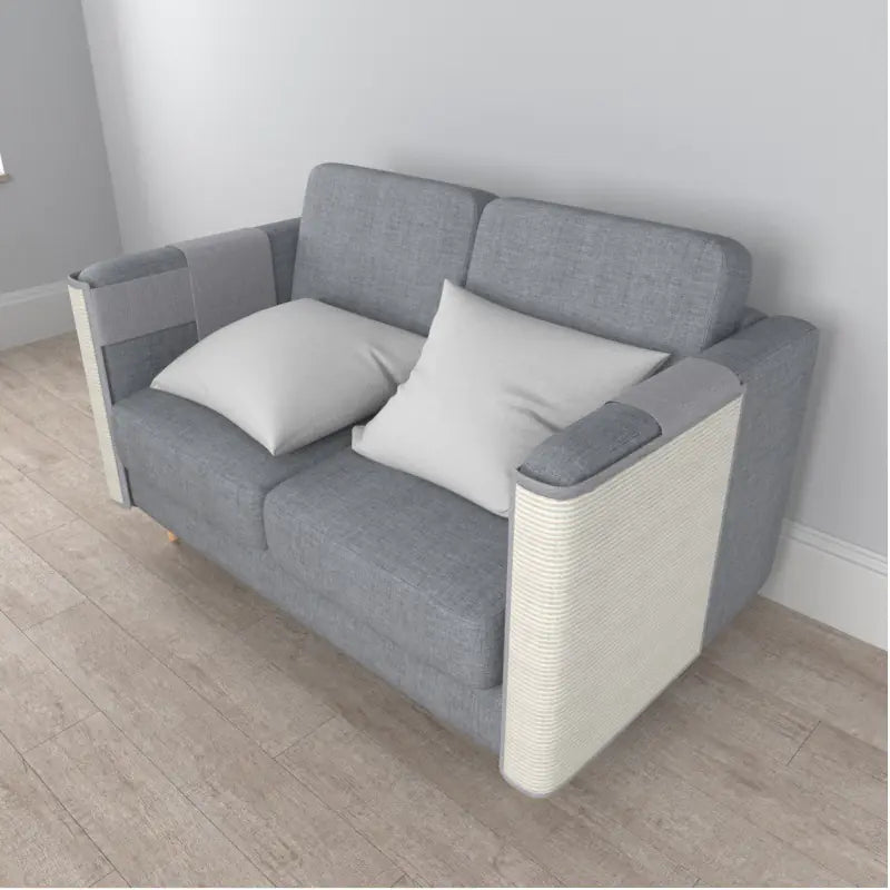 Gray sofa with white cushions on a wooden floor and light gray walls