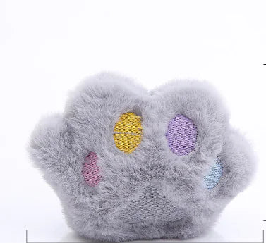 Plush toy resembling a paw with colorful accents on a white background