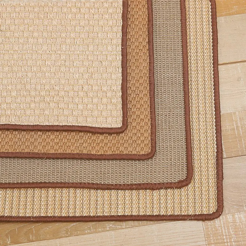 Beige and brown woven rug on a wooden floor