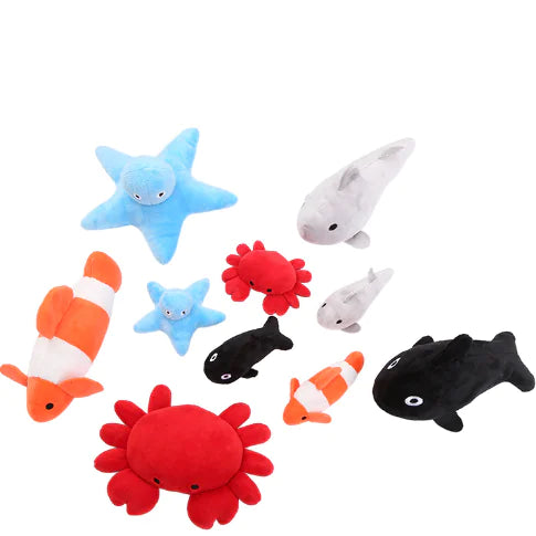 Collection of colorful plush ocean-themed toys on a white background