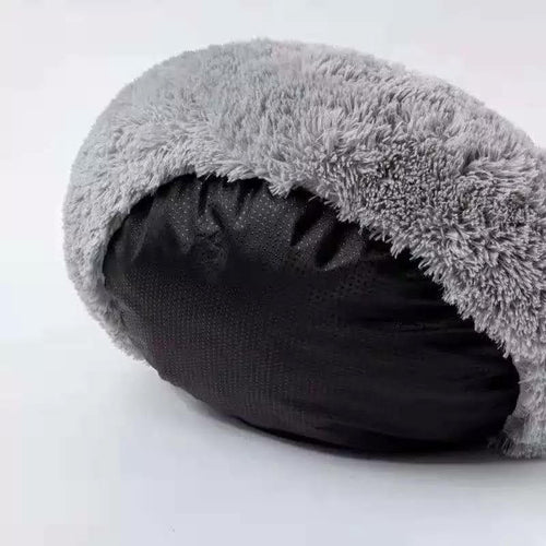 Gray fuzzy pet bed on a white background