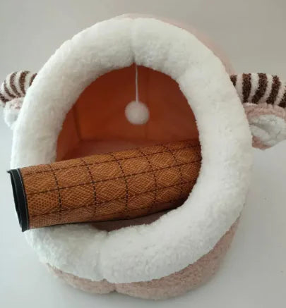 Pet bed with striped exterior and textured interior on a white background