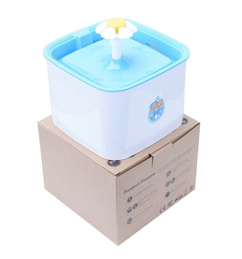 Pet water fountain on a cardboard box with a white background